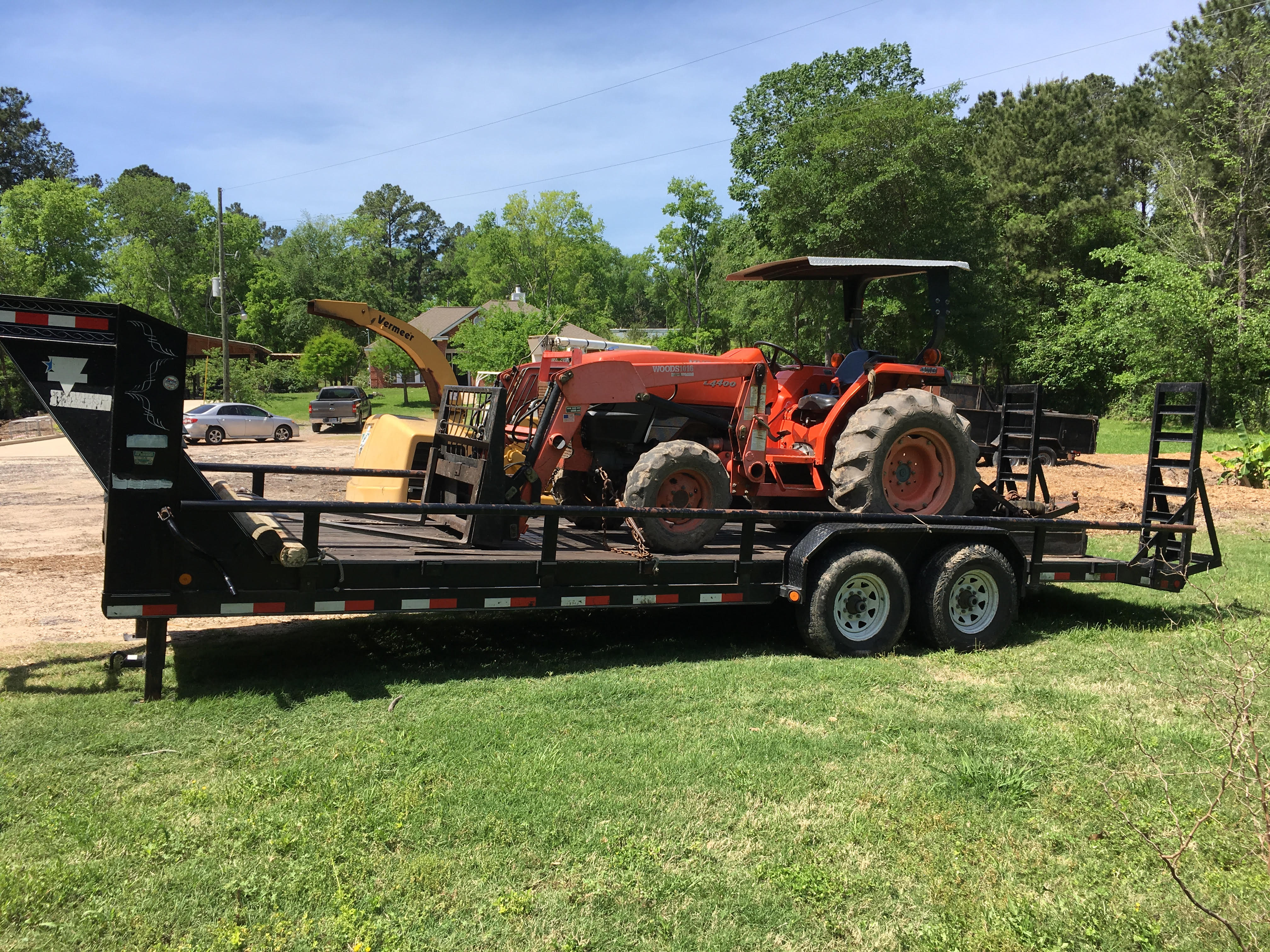 Ignacio Villa's Tree Service bucket truck loaded with cut logs after a tree removal job