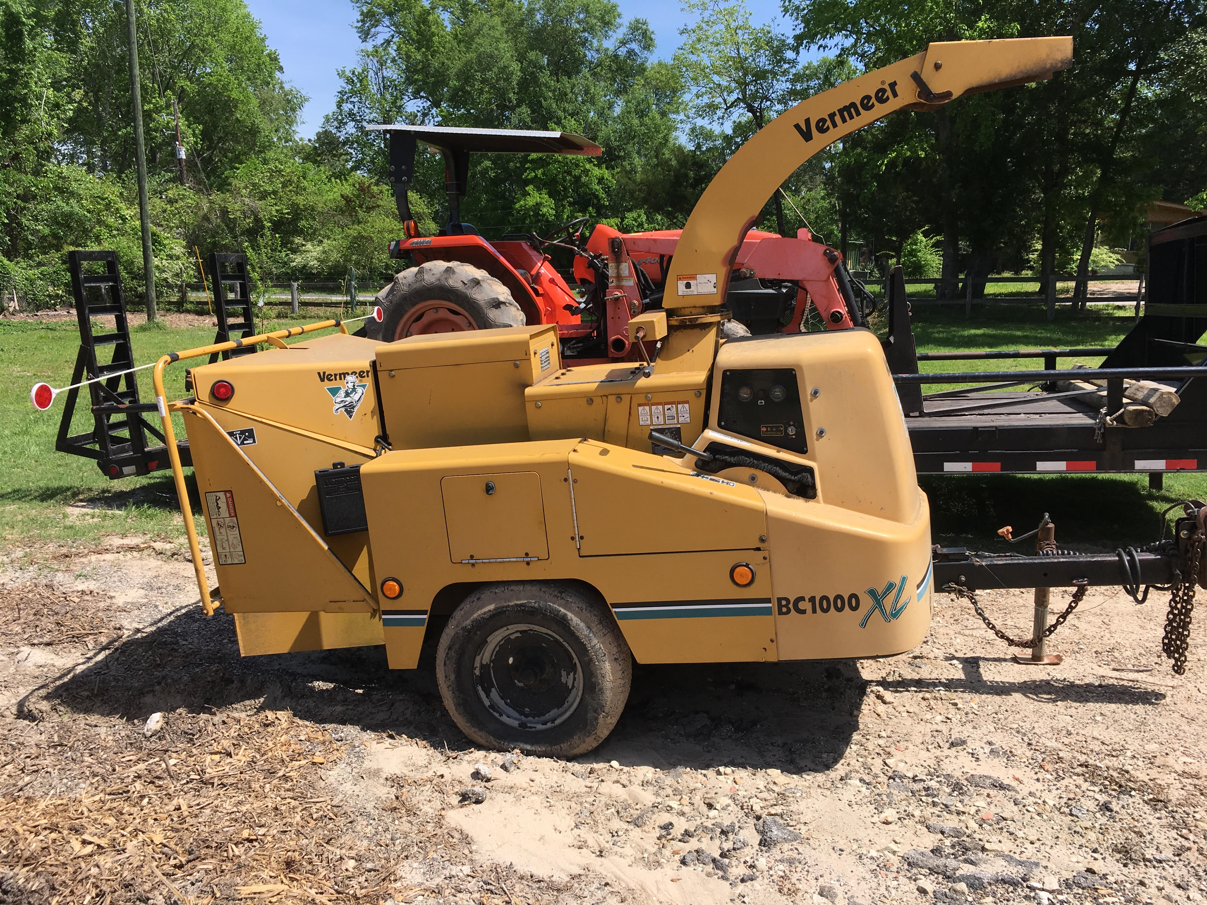 Bucket truck boom raised into the tree canopy at a job site near Huntsville, TX